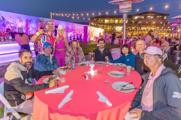 Group of people sitting around a table at party