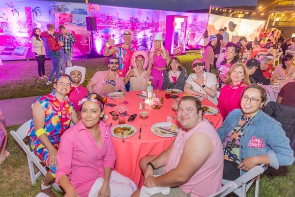 Group of people at a table looking at the camera